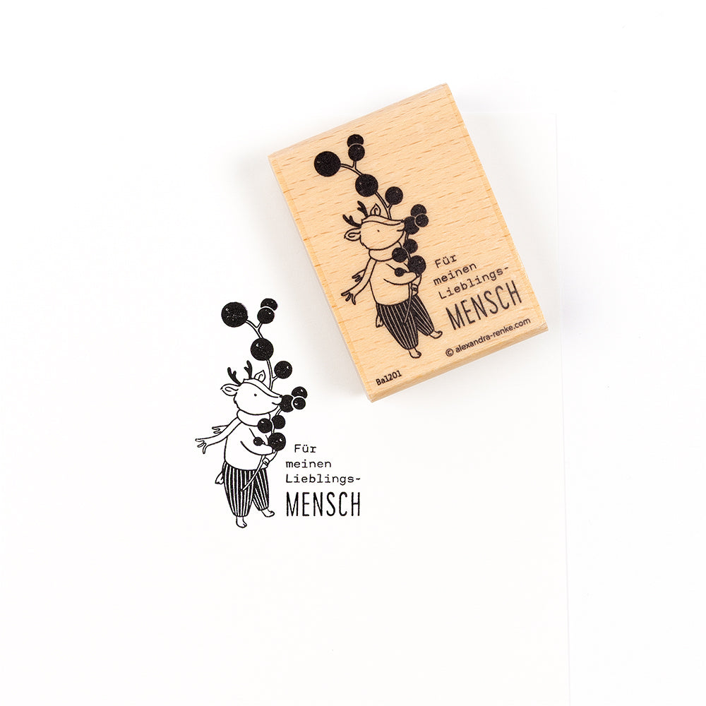 Ein „Lieblingsmensch“-Stempel aus Holz mit dem Stempelmotiv eines Rehs, das Beeren hält, und dem deutschen Text „Für meinen Lieblings-MENSCH…“.