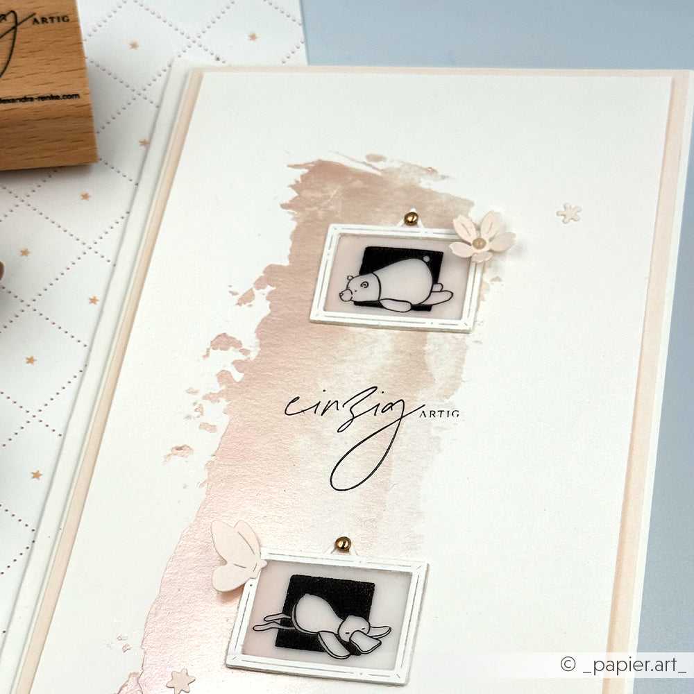 Handgefertigte Karte von Alexandra Renke mit zwei Cartoon-Siegeln im Rahmen, rosa Aquarellfarben, Schmetterlingspapier-Akzenten und zarten, gestempelten Details für zusätzlichen Charme.