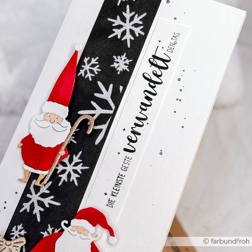Handgemachte Karte von Alexandra Renke mit Weihnachtsmannfiguren, weißen Schneeflocken auf schwarzem Grund und deutschem Text auf weißem Grund - hergestellt mit Holzstempeln für einzigartige Papierprojekte.