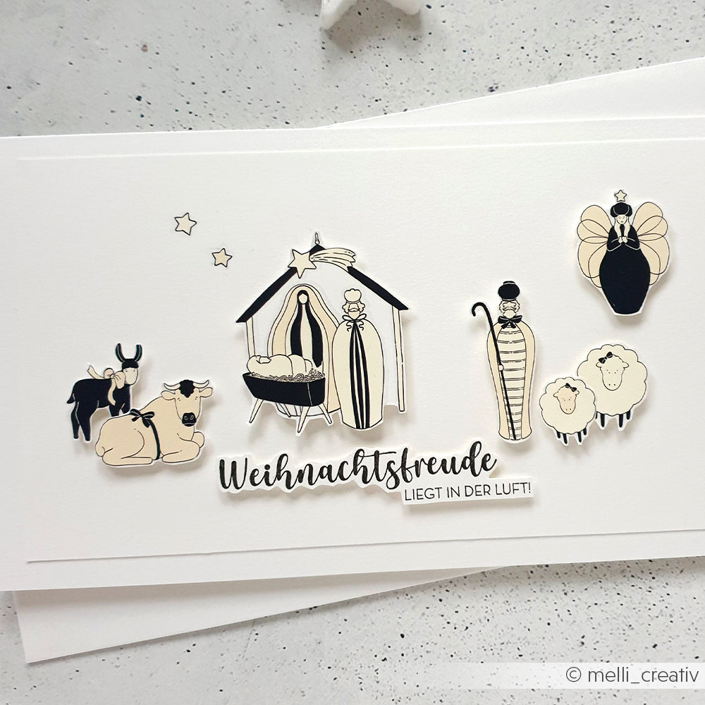 Weihnachtliche Krippenillustration mit Tieren und Engeln und dem fröhlichen Text "Weihnachtsfreude liegt in der Luft!" - ideal für Ihren nächsten Alexandra Renke Holzstempel oder Stempelgummi.
