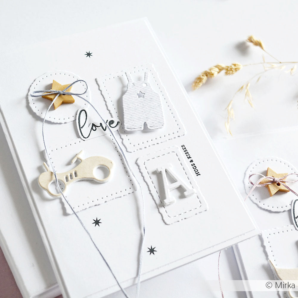 Eine handgefertigte weiße Grußkarte von Alexandra Renke mit Details zum Thema Baby, "Liebe", Schnur und Sternen, hergestellt mit Dies und Motivstanze Strampler für zusätzlichen Charme.