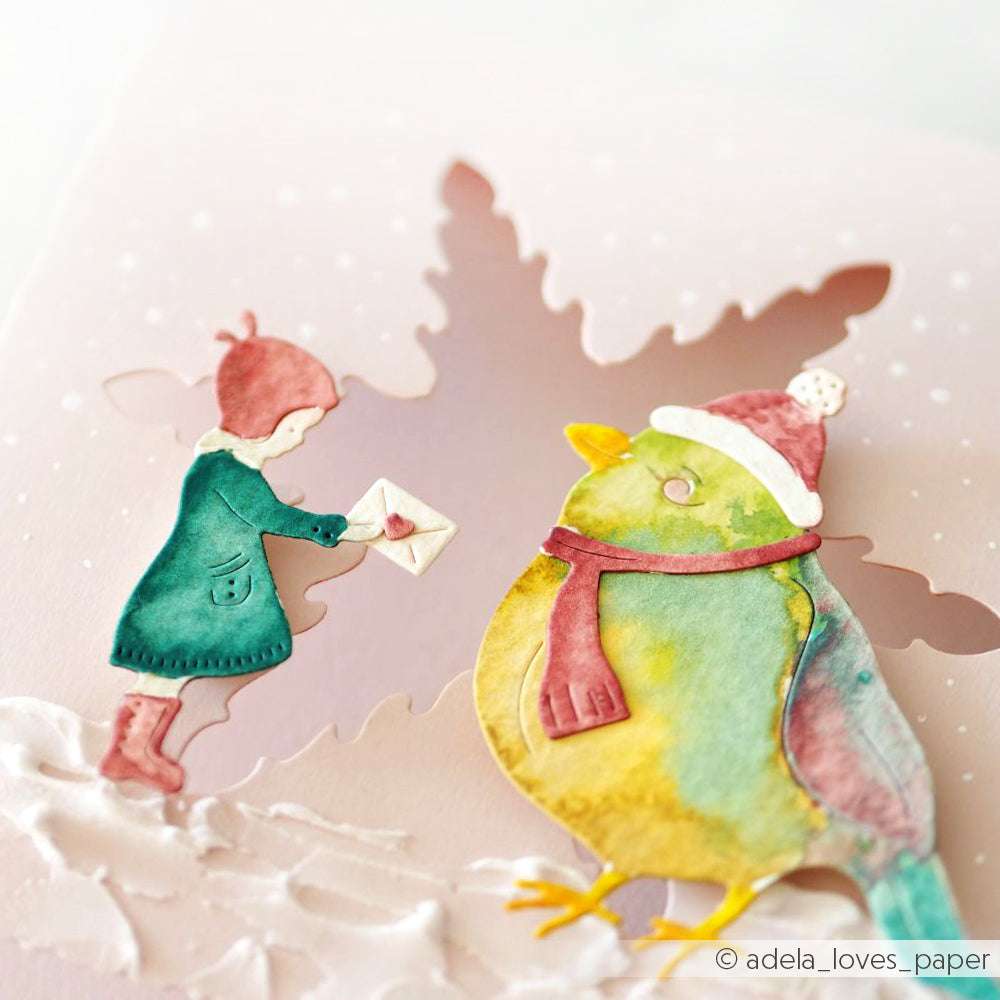 Ein Mädchen überreicht einem großen, bunten Vogel in einer verschneiten Szene einen Brief - perfekt zum Basteln mit Alexandra Renkes Motivstanze Kind mit Vögelchen und passenden Stanzsystemen dies.