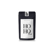Ein schwarzer Beutel mit Tateetata-Bratapfel-Früchtetee mit der Aufschrift „HO HO ho...“.