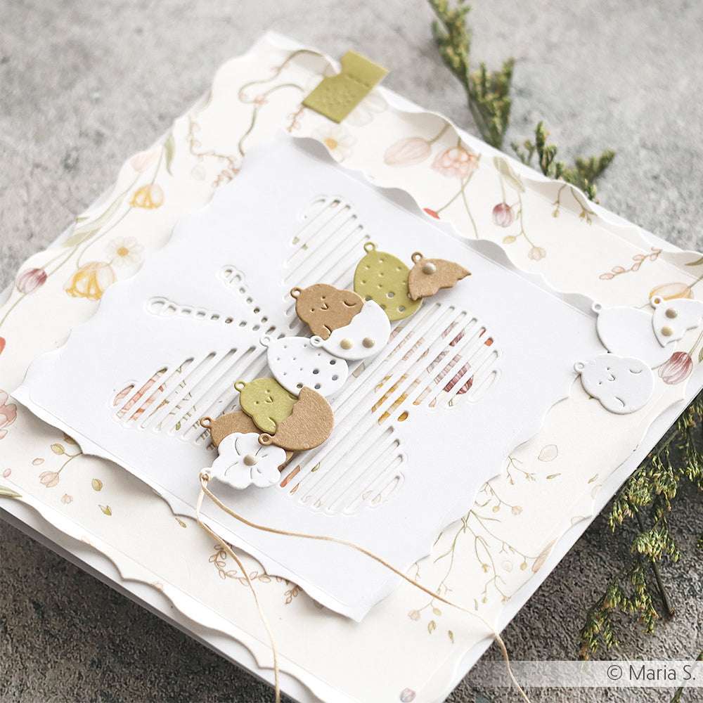 Handgemachte Karte von Alexandra Renke mit einem ausgeschnittenen Schmetterling mit Deep Edge Motivstanzen, verziert mit kleinen Papierblättern und Blumen auf einem floralen Hintergrund.