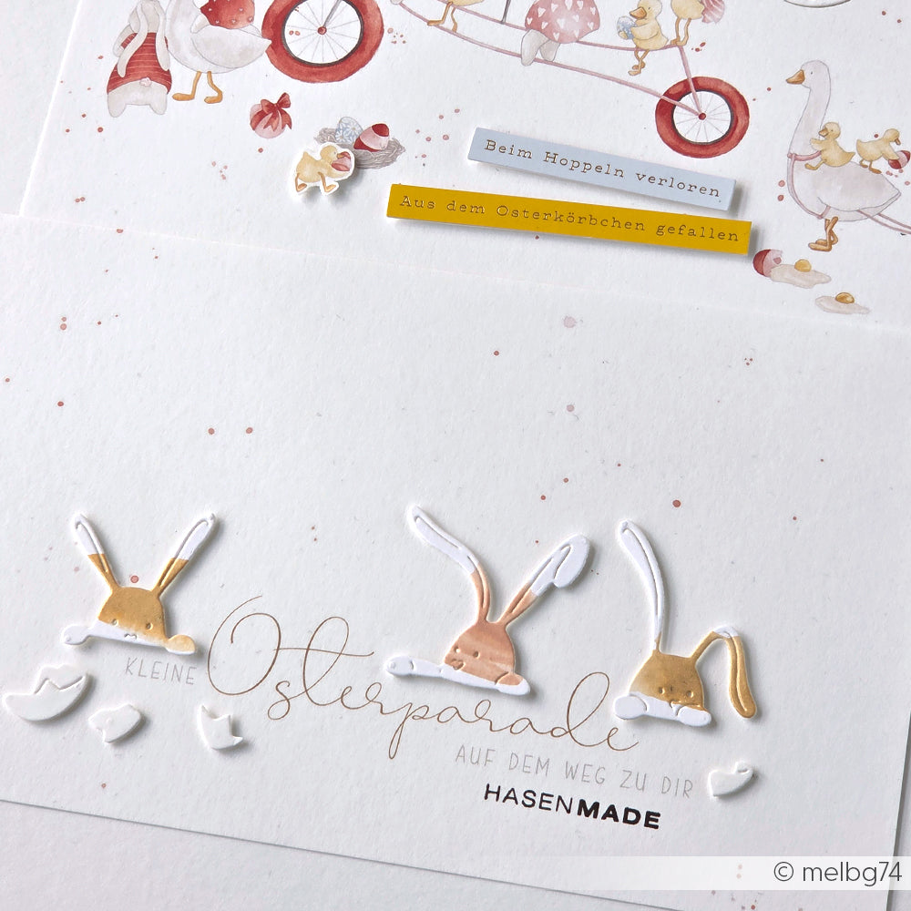 Die weiße Karte von Alexandra Renke zeigt Hasenohren, Pastellfarben und einen deutschen Text über eine Osterparade und Eierschalen. Ideal zum Basteln mit Designpapieren oder zum Verzieren mit der Motivstanze Neugierige Häschen.