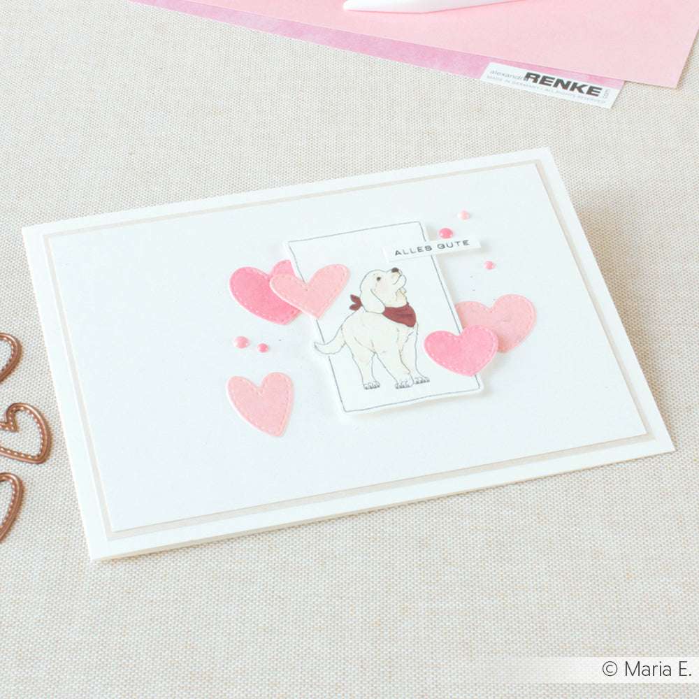 Grußkarte von Alexandra Renke mit einer Hundeillustration, rosa Herzen und "Alles Gute" auf hellem Hintergrund - ideal für Papierprojekte oder als schöne Grußkarte.