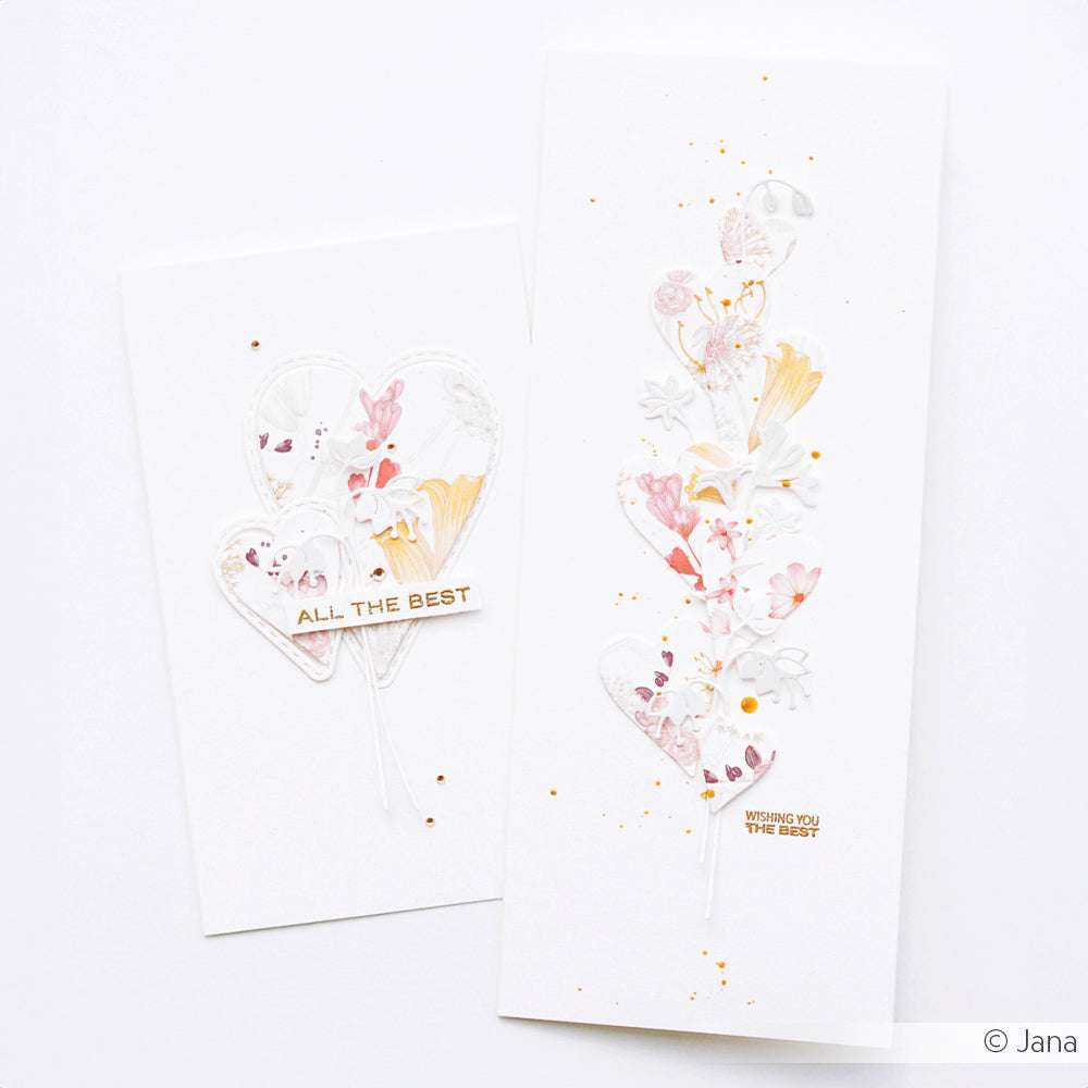 Zwei weiße Grußkarten von Alexandra Renke mit floralen Motiven in Herzform und goldgeprägten Botschaften - ideal für Papierprojekte oder zum Versenden einer herzlichen Nachricht.