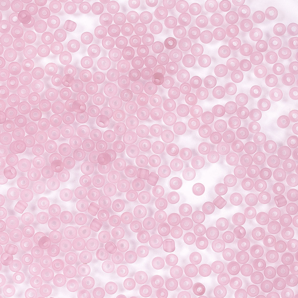 Hunderte kleiner, durchscheinender, rosa Mini-Glasperlen, die sich perfekt zum Schmuckbasteln eignen, sind zufällig auf einer weißen Fläche verteilt und warten nur darauf, Sie zu Ihren nächsten Bastelprojekten zu inspirieren.
