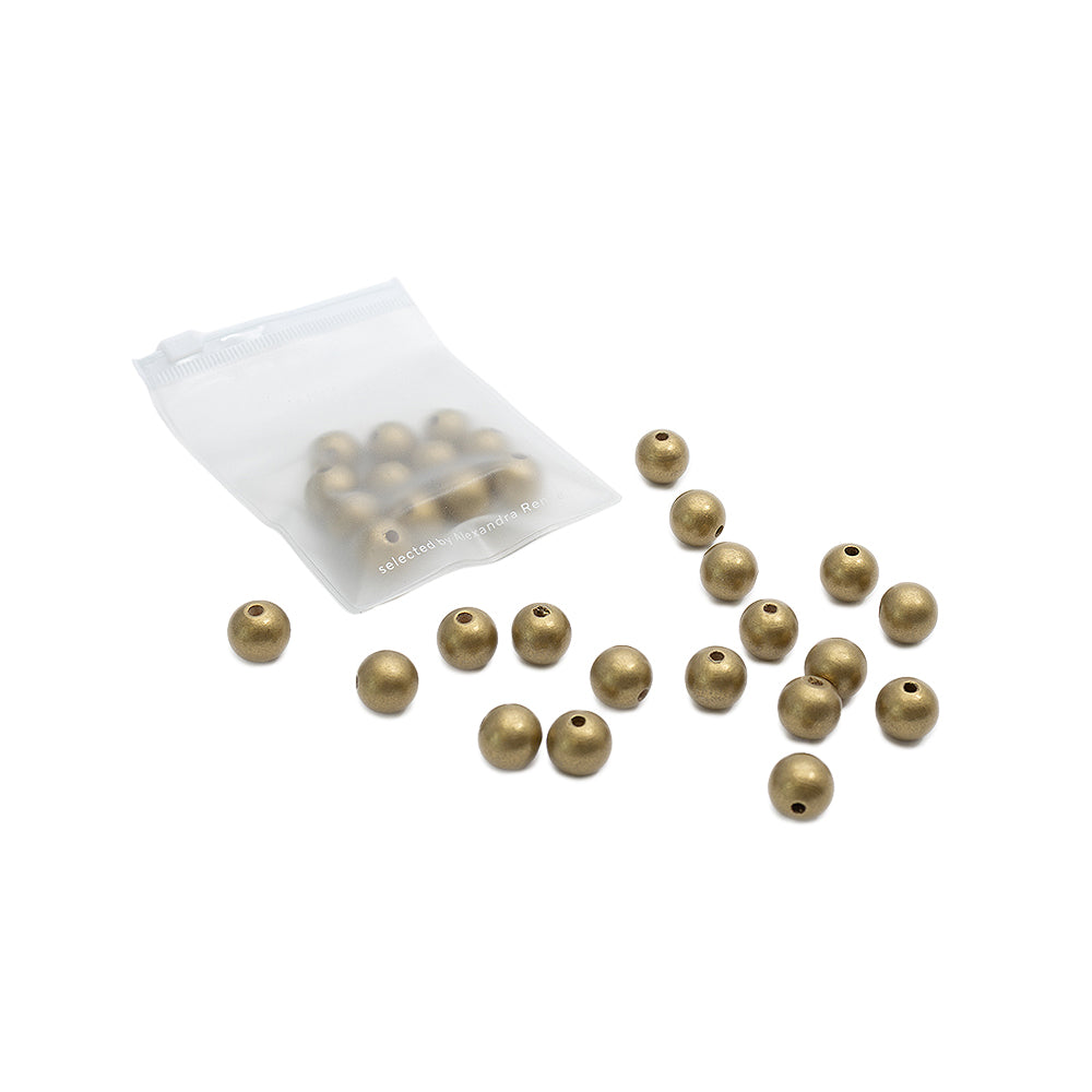 Kleine runde Goldperlen von Alexandra Renke, teils lose, teils in einem durchsichtigen Plastikbeutel, auf weißem Hintergrund – perfekt, um Ihrem nächsten Bastelprojekt einen Hauch von Glanz zu verleihen.