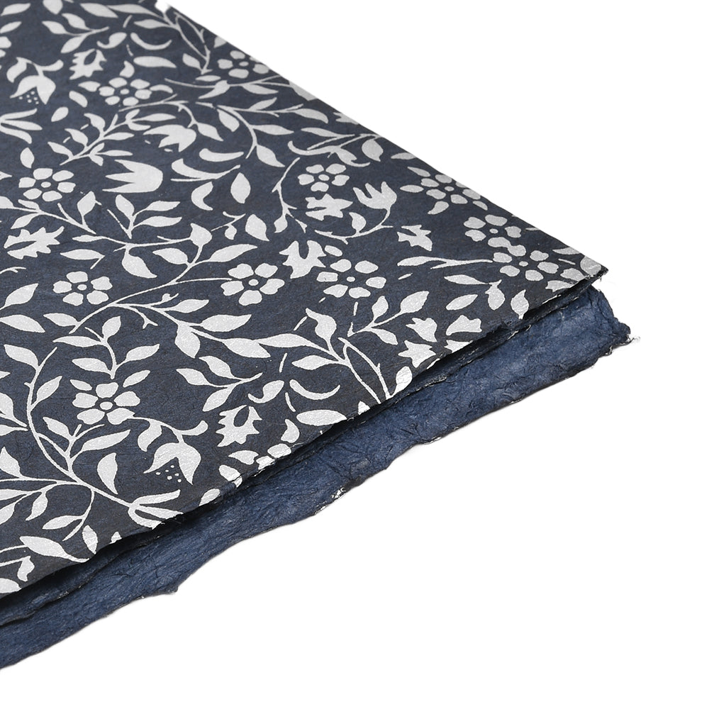 Das marineblaue Nepalpapier von ☆ hat ein weißes Blumenmuster und strukturierte Kanten - ideal als einzigartiges Geschenkpapier.
