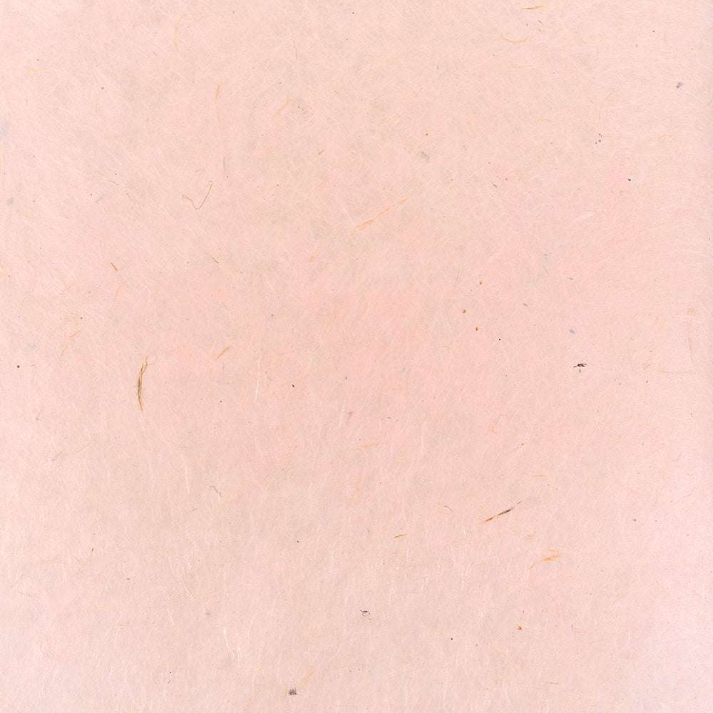 Nepalpapier in Hellrosa mit strukturierter Oberfläche, zarten Fasern und winzigen Tupfen - perfekt zum Buchbinden oder eleganten Verpacken von Geschenken.