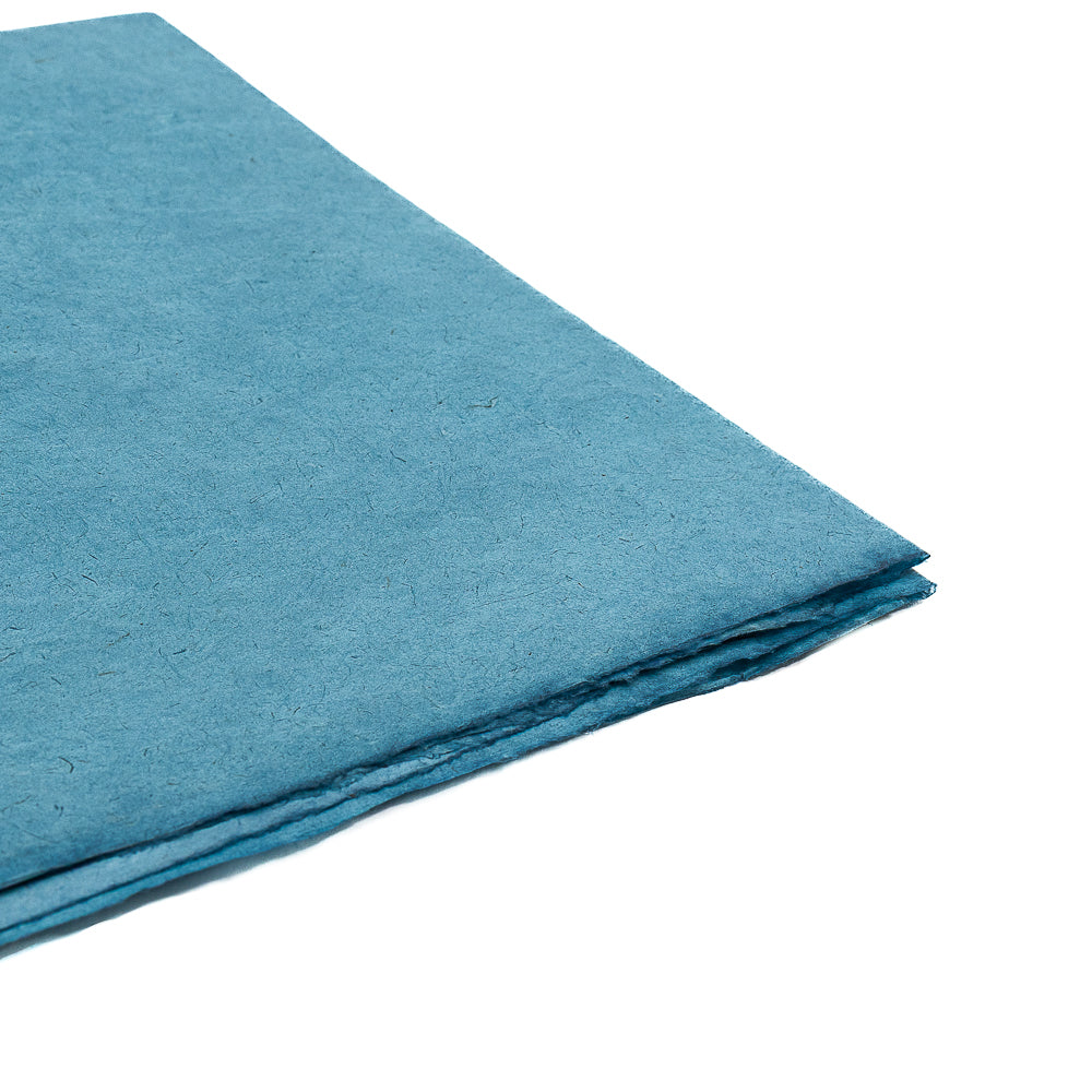 Drei Bögen handgeschöpftes blaues Nepalpapier von ☆ sind auf weißem Hintergrund gestapelt – ideal als nachhaltiges Geschenkpapier.