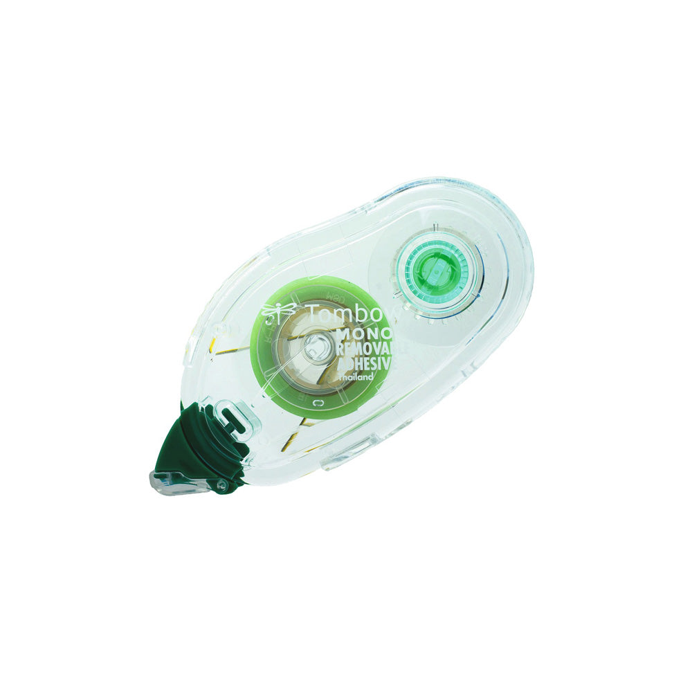 Tombow-Korrekturbandabroller aus durchsichtigem Kunststoff mit grünem Rad und grüner Spitze auf weißem Hintergrund.