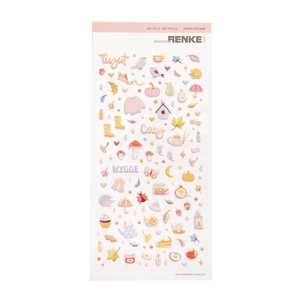 Ein Bogen mit Puffy-Sticker-Motiven zum Thema Gemütlichkeit – perfekt für dein Bullet Journal oder kreative Projekte –, darunter Pullover, Blätter, Tassen, Kürbisse und Herbstsymbole.