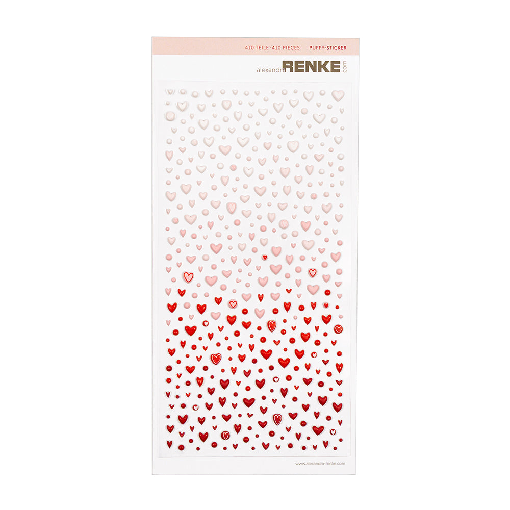 Bogen mit gepolsterten Herzaufklebern, deren Farbe von Hellrosa zu leuchtendem Rot übergeht.