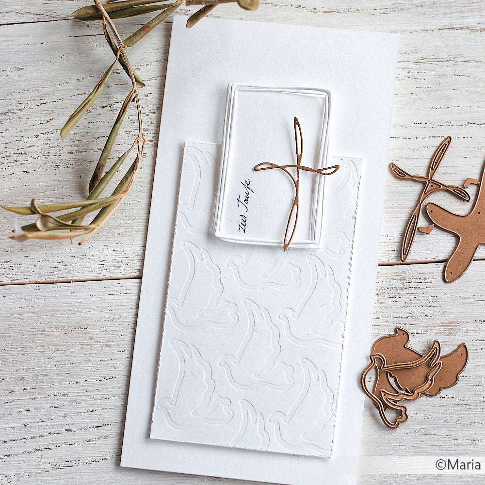 Die minimalistische weiße Karte von Alexandra Renke mit Motivstanze und geprägtem Taubenmotiv wird mit einer goldenen Taubenklammer aus Draht kombiniert und neben den Metallklammern auf dem Tisch präsentiert.