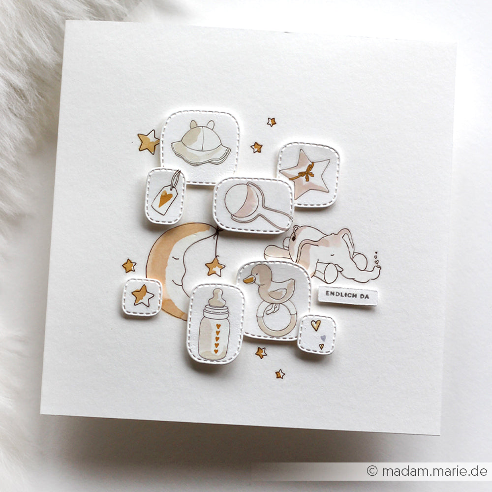 Handgefertigte Karte von Alexandra Renke mit pastellfarbenen Baby-Zeichnungen und Rub-On-Motiven - Flasche, Schnuller, Mond, Sterne, Mütze, schlafendes Baby - ideal für Transferfolien Basteln oder um Babyfreude Blau Akzente zu setzen.