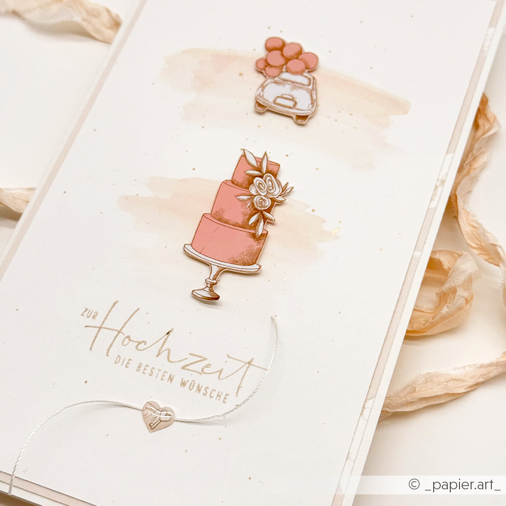 Alexandra Renke Hochzeitskarte mit rosafarbener Torte, Auto und Luftballons, mit dem Text "Zur Hochzeit Die besten Wünsche" - perfekt für Bastelprojekte und kann mit Ihren Lieblingsmotiven oder Rub-On Transferfolien gestaltet werden.