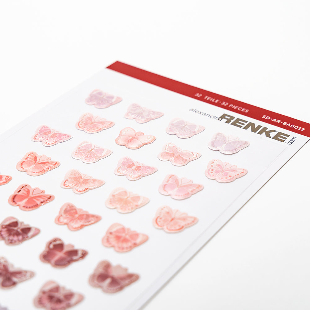 Ein Bogen mit Alexandra Renke rosa und roten Schmetterlingsaufklebern, ideal für die Kartengestaltung. In ordentlichen Reihen auf Weiß angeordnet, bringen diese Schmetterlinge Rottöne lebendigen Charme in jedes Projekt.