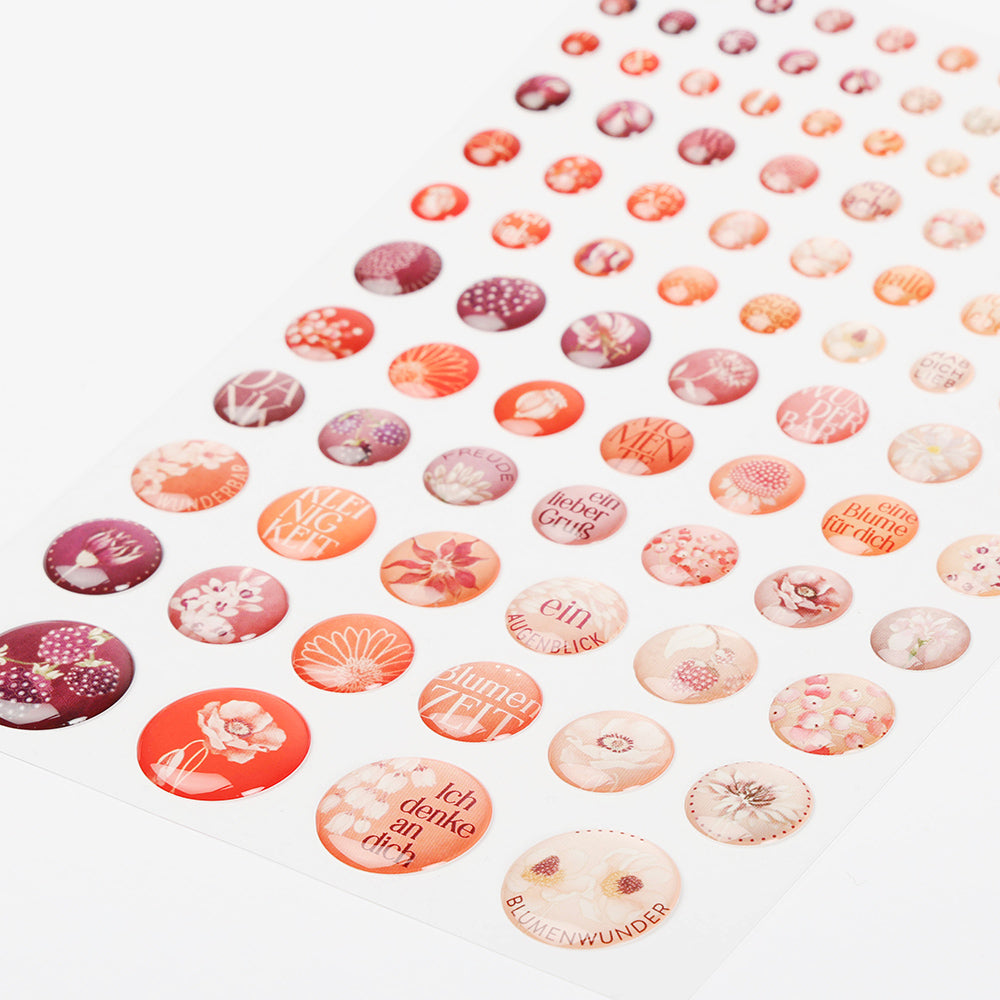 Bogen runder Sticker Dots von Alexandra Renke in Rot und Rosa mit floralen Motiven und deutschen Wörtern, ideal für Buchbindearbeiten oder um Ihren Basteleien einen charmanten Touch zu verleihen.