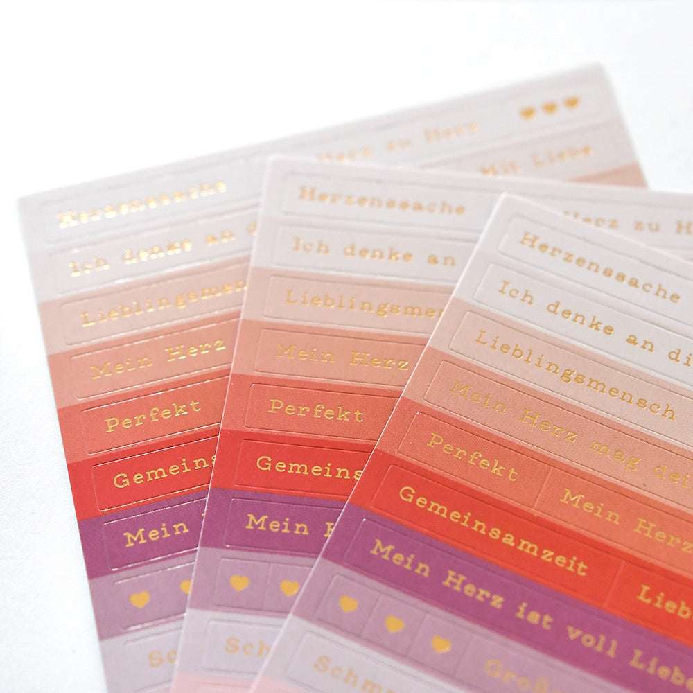 Drei Bögen Alexandra Renke Aufkleber mit deutschen Wörtern und Sätzen in Gold - ideal für die Gestaltung von Karten oder zum Verzieren mit eleganten Aufkleberstreifen.