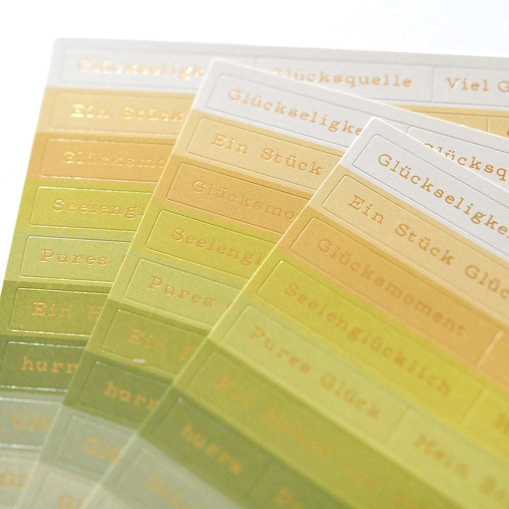 Rechteckige Sticker-Streifen von Alexandra Renke in Gelb und Grün mit goldenen deutschen Wörtern - ideal zur Kartengestaltung oder zum Verzieren Ihrer kreativen Projekte.