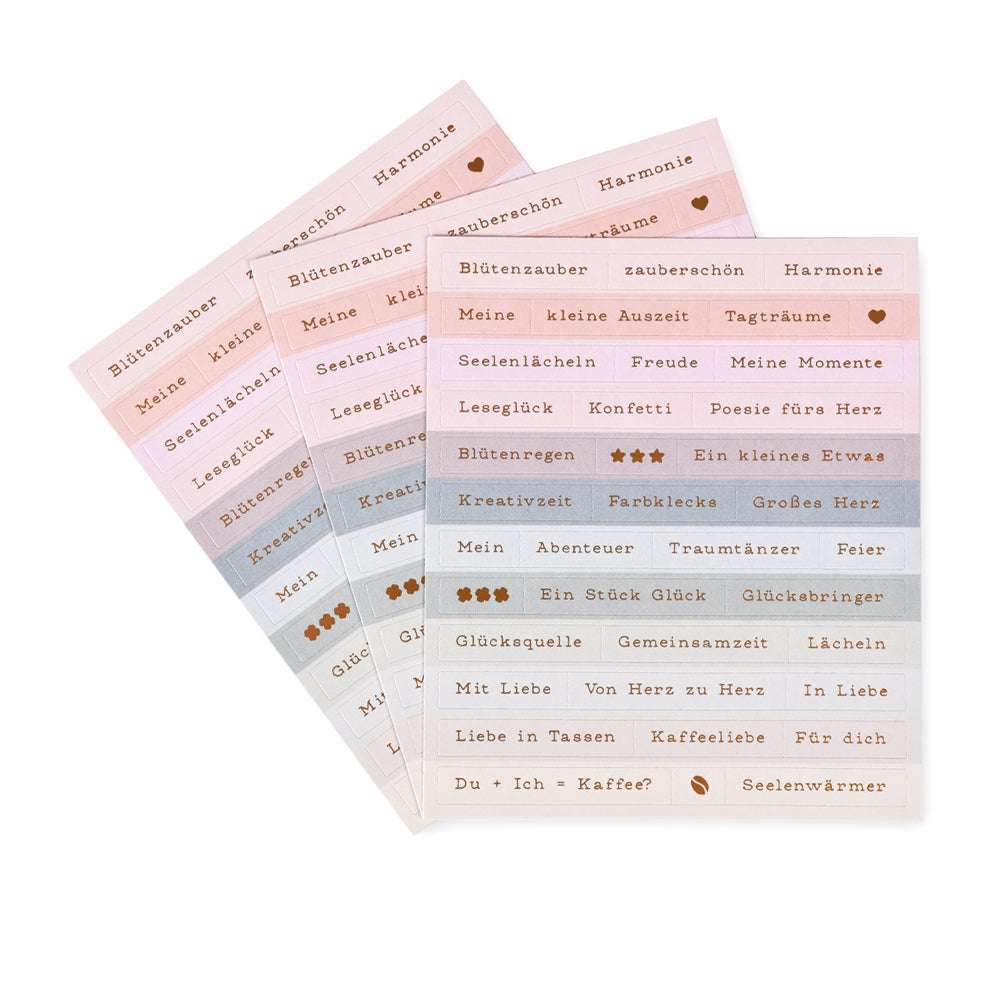 Drei pastellfarbene Stickerbögen von Alexandra Renke mit deutschen Wörtern und kleinen Symbolen in ordentlichen Reihen - perfekt für die Kartengestaltung oder um Ihren Projekten einen Hauch von Blumenzauber zu verleihen.
