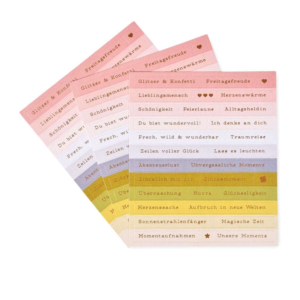 Vier pastellfarbene Stickerbögen von Alexandra Renke für Kartengestaltung, mit deutschen Wörtern in Gold, Weiß und Schwarz. Inklusive lustiger Sticker-Streifen, um Ihren kreativen Projekten Glitzer- und Konfetti-Flair zu verleihen.