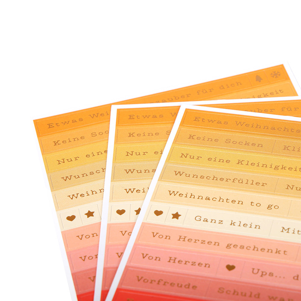 Orangefarbene und gelbe Sticker-Streifen von Alexandra Renke mit deutschem Text und kleinen Symbolen wie Sternen und Herzen - ideal zum Basteln von Karten oder kleinen Geschenken.