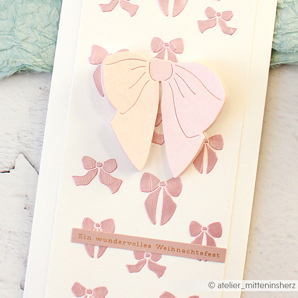 Eine handgefertigte Alexandra Renke Karte mit rosa Schleifen und dem deutschen Gruß "Ein wundervolles Weihnachtsfest". Perfekt zum Basteln von Karten oder zum Verzieren kleiner Geschenke.
