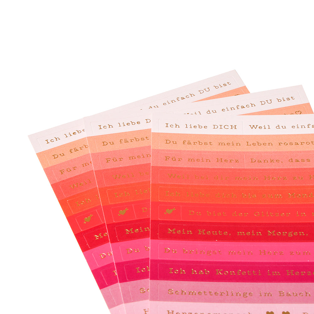 Vier Bögen mit rosa, roten und orangefarbenen Alexandra Renke Sticker-Streifen mit deutschem Text in Gold - ideal zum Basteln von Karten oder zum Hinzufügen von Liebesbotschaften.