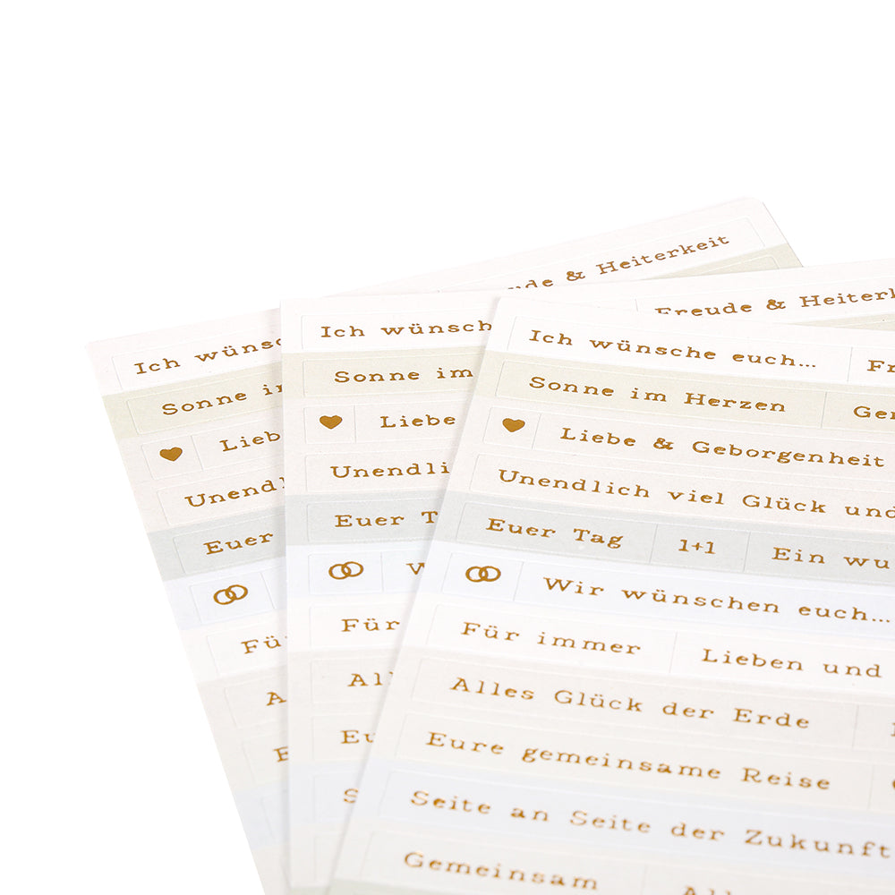 Drei goldbedruckte Bögen mit deutschen Grußetiketten von Alexandra Renke, ideal zur Kartengestaltung und Dekoration. Mit verschiedenen feierlichen Botschaften und Symbolen - perfekt als Aufkleber für Hochzeitsgrüße.