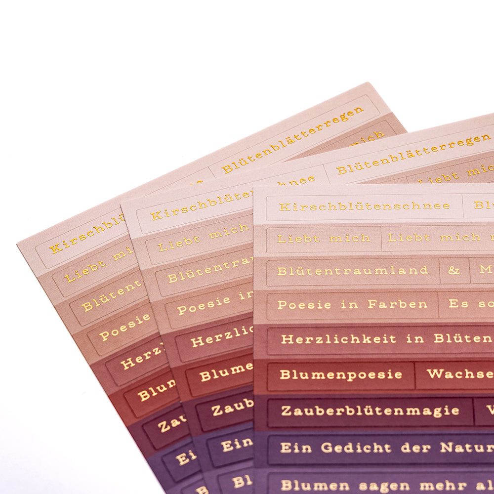Vier farbverlaufende Sticker-Streifen-Bögen von Alexandra Renke mit goldfarbenem Text, ideal für Blumenpoesie oder Kartengestaltung, fächerförmig angeordnet.