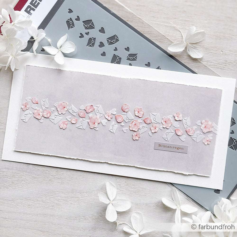 Handgemachte Karte mit rosa und weißen Blumen auf grau, daneben ein Schmetterling und eine Alexandra Renke wiederverwendbare Schablone Herzchenstreifen-perfekt für Schablone Papierprojekte.