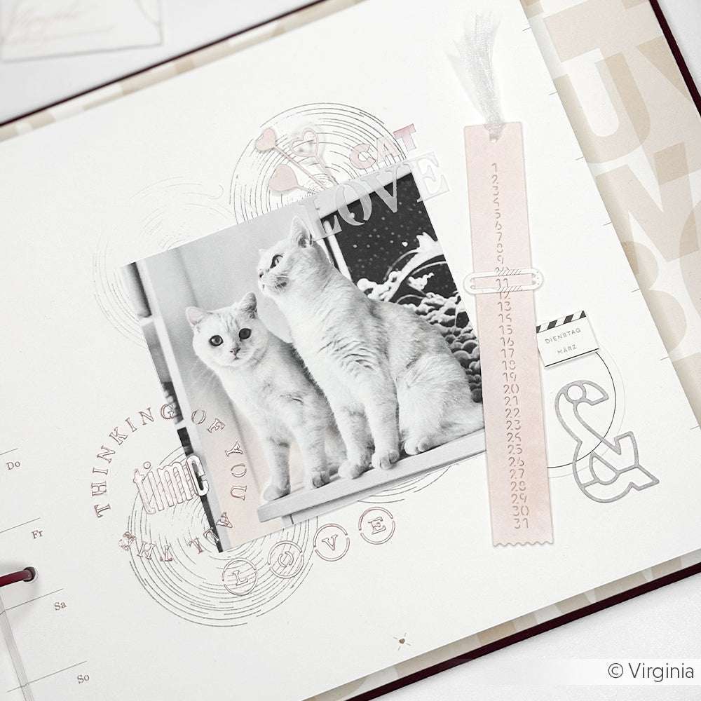 Eine Scrapbook-Seite von Alexandra Renke mit einem Schwarz-Weiß-Foto von zwei Katzen, dekorativem Text, einem rosa Lesezeichen und eleganten Schablonendetails - perfekt für Ihre Papierprojekte.