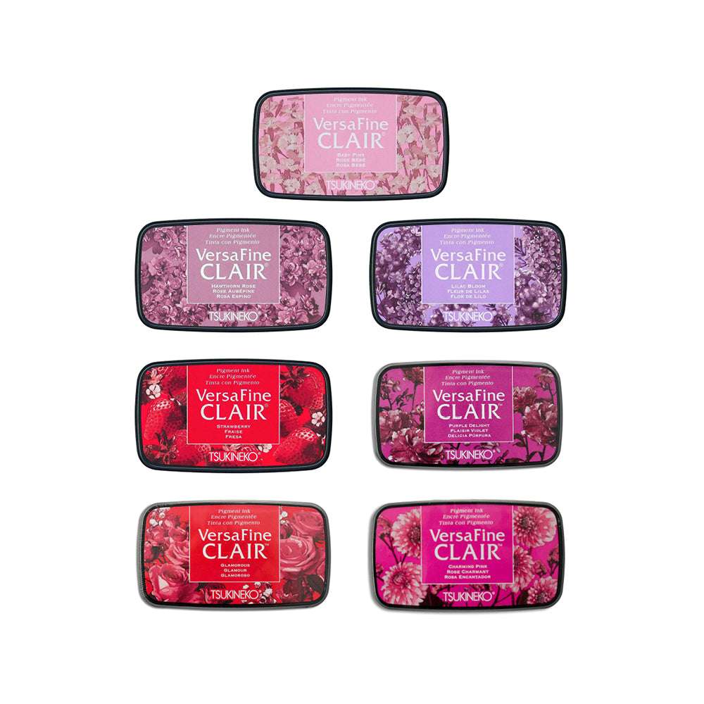 Sieben Tsukineko VersaFine Clair Stempelkissen in rosa, roten und violetten Pigmenttönen sind in einer markanten Pyramidenform angeordnet.