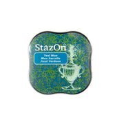 Ein Tsukineko StazOn Stempelkissen in Teal Blue, farbecht und wasserbeständig, mit dekorativer Urne und Blumenmotiv auf dem Etikett-perfekt für glatte Oberflächen.