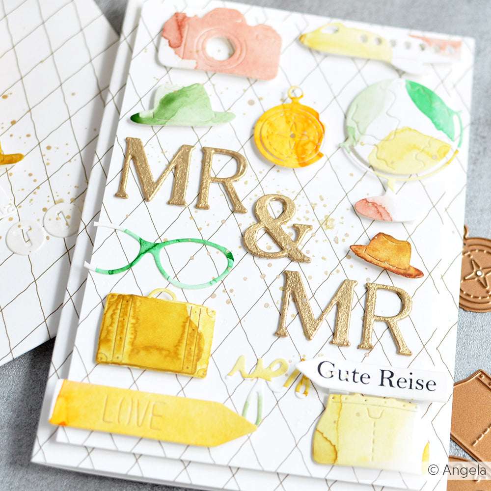 Handgefertigte Karte mit Reise-Symbolen aus dem Alexandra Renke Motivstanze Reise Set, mit goldenem "MR & MR"- und "Gute Reise"-Text auf strahlend weißem Hintergrund.