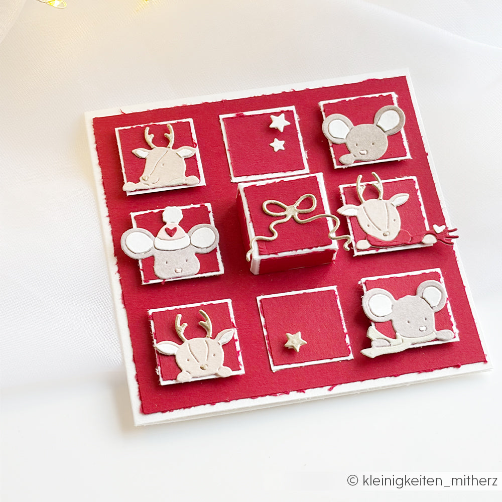 Handgefertigte Weihnachtskarte mit rotem Rastermuster und Mäusen und Rentieren aus der Motivstanze Neugierige Tierchen.