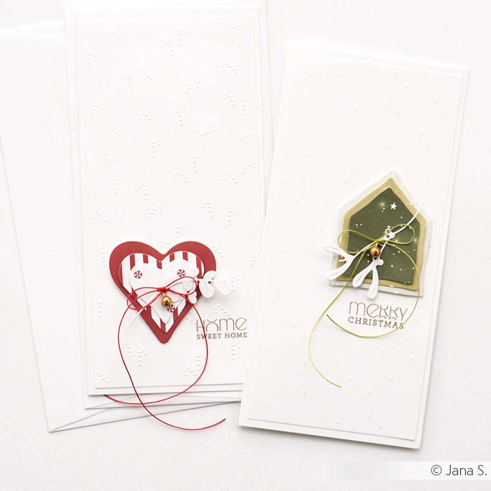 Zwei festliche, handgefertigte Weihnachtskarten von Alexandra Renke in Clear Stamp Technik - eine mit einem Herz, die andere mit einem Haus - sind perfekt für Ihre Papierprojekte.