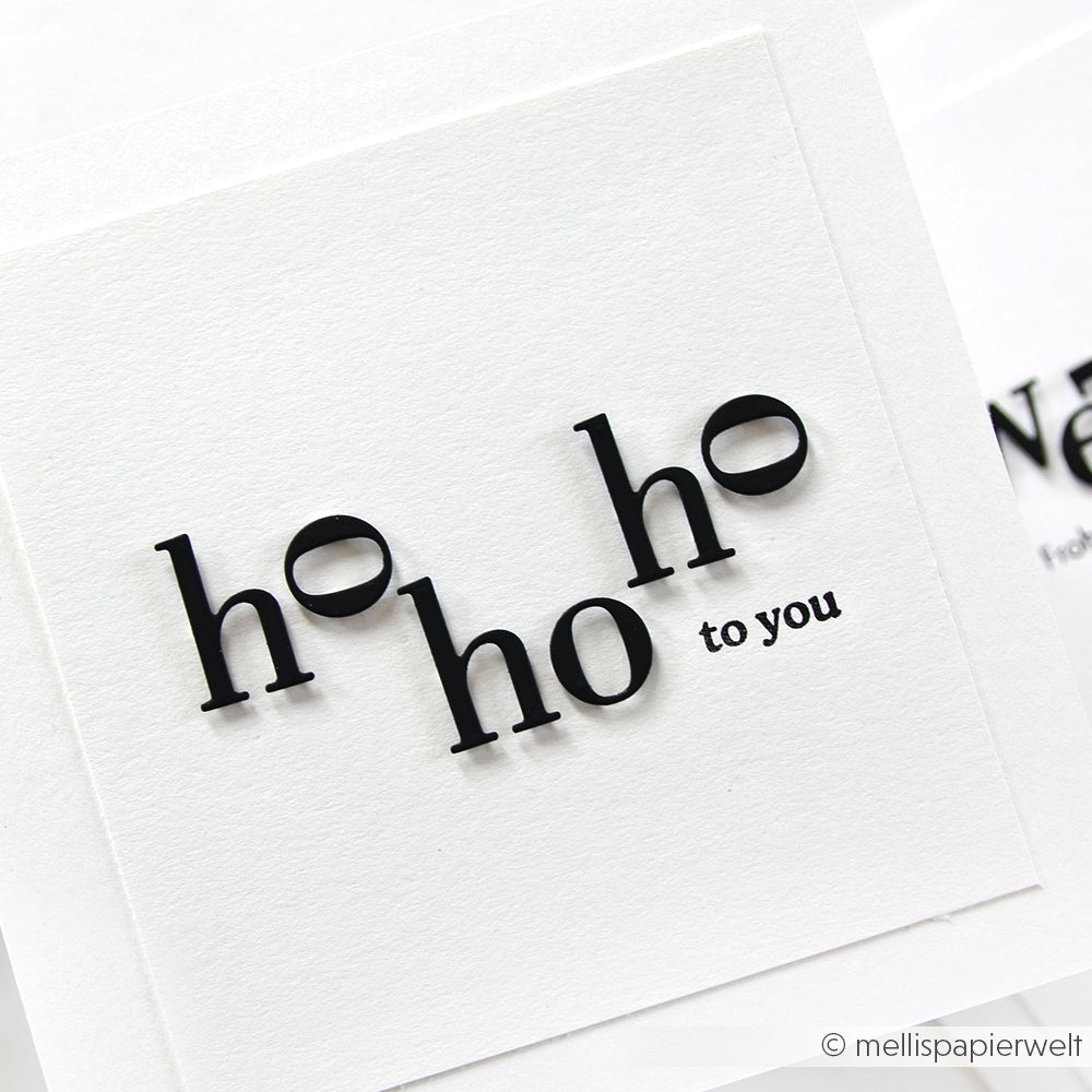 Weiße Karte mit "ho ho ho to you" in schwarzer Schrift, jeweils ein halbgefüllter Kreis - gestaltet mit Alexandra Renke Motivstanze Serifbuchstaben klein und hochwertigem Designpapier, ideal für kreative Stanzsysteme-Projekte.