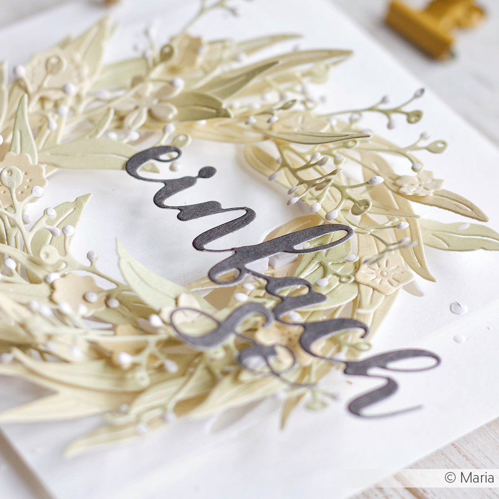 Ein zarter Papierkranz mit dem Schriftzug "einfach" in grauer Schreibschrift auf weißem Grund wurde mit dem Schriften-Duo Einfach so Stanzsysteme von Alexandra Renke gefertigt und mit einer schicken Motivstanze veredelt.