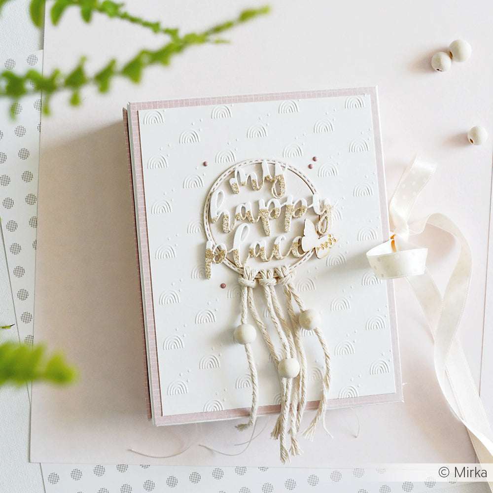 Handgemachte Karte von Alexandra Renke mit dem Text "stay happy always", Quasten, Perlen, einem cremefarbenen Band und eleganten Designpapieren auf hellem Hintergrund.