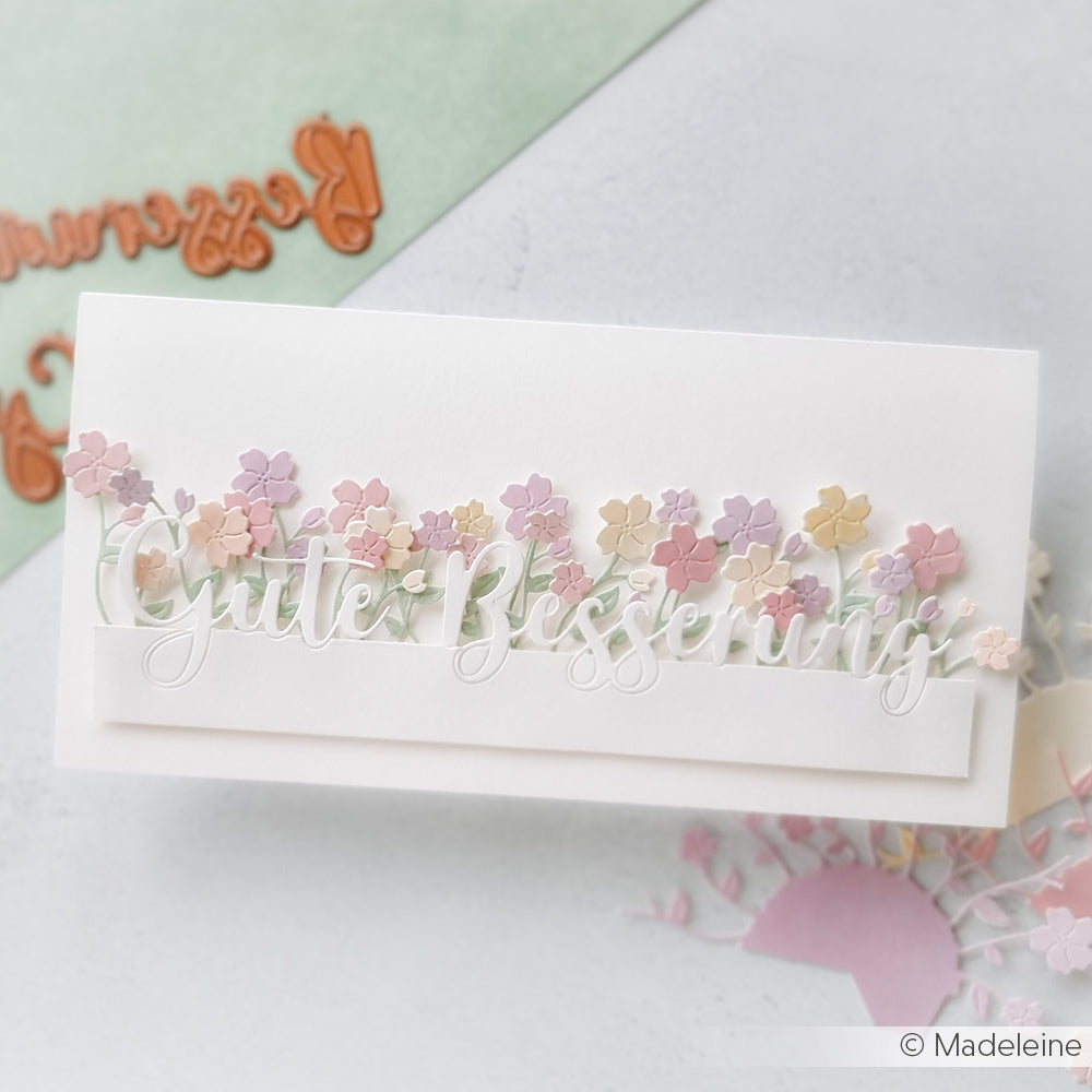 Handgefertigte Karte "Gute Besserung" von Alexandra Renke, gestaltet mit dem Motivstanze Schriften-Duo Gute Besserung und verziert mit pastellfarbenen Papierblumen auf weißem Hintergrund.