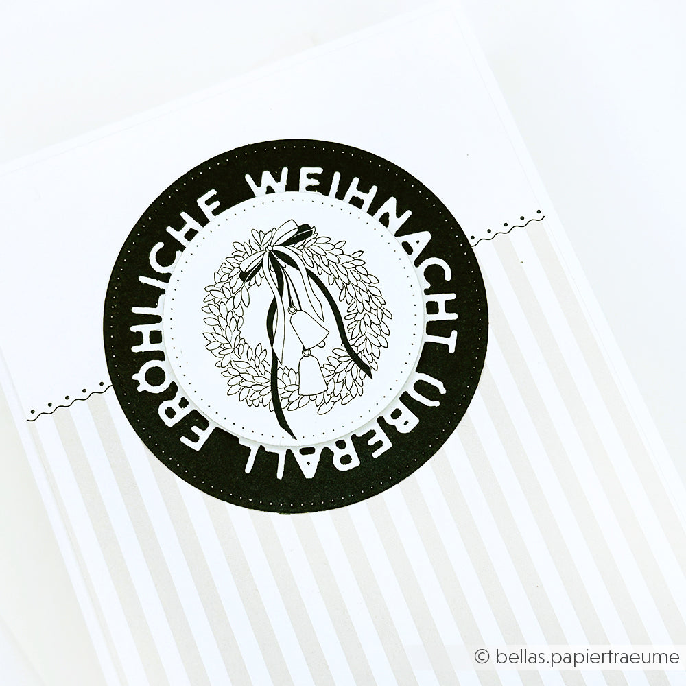 Schwarz-weiße Alexandra Renke Weihnachtskarte mit Kranz und dem Text "Fröhliche Weihnachten überall", hergestellt mit Designpapieren und Stanzsystemen.