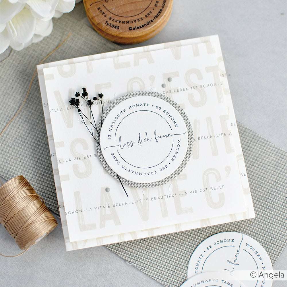 Quadratische Grußkarte von Alexandra Renke mit deutschem Text, einem runden Etikett, getrockneten Blumen, Bindfaden und weißen Blüten - ideal für Papierprojekte oder zur Personalisierung mit einem Holzstempel-Design.