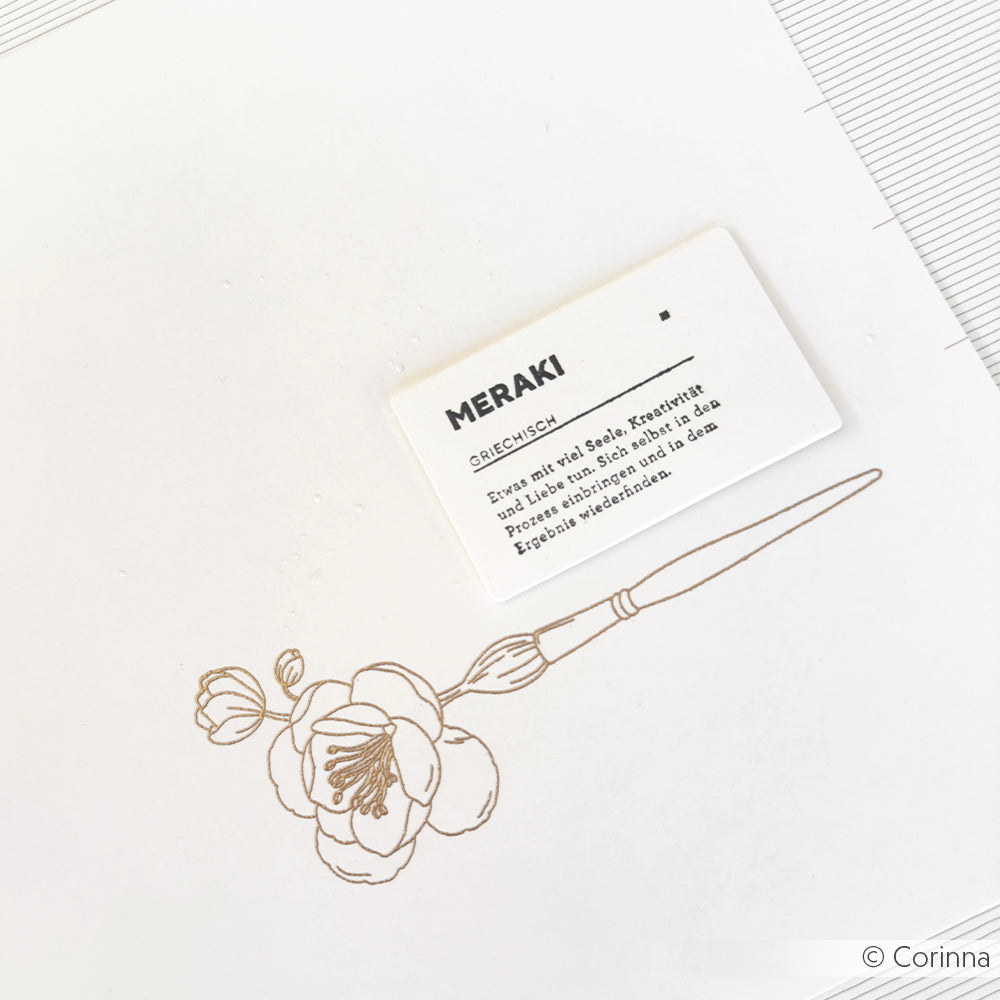 Minimalistische Zeichnung einer Blume und eines Pinsels mit einer kleinen Karte mit der Aufschrift MERAKI von Alexandra Renke - ideal für Papierprojekte oder in Kombination mit Ihrem Lieblingsholzstempel.