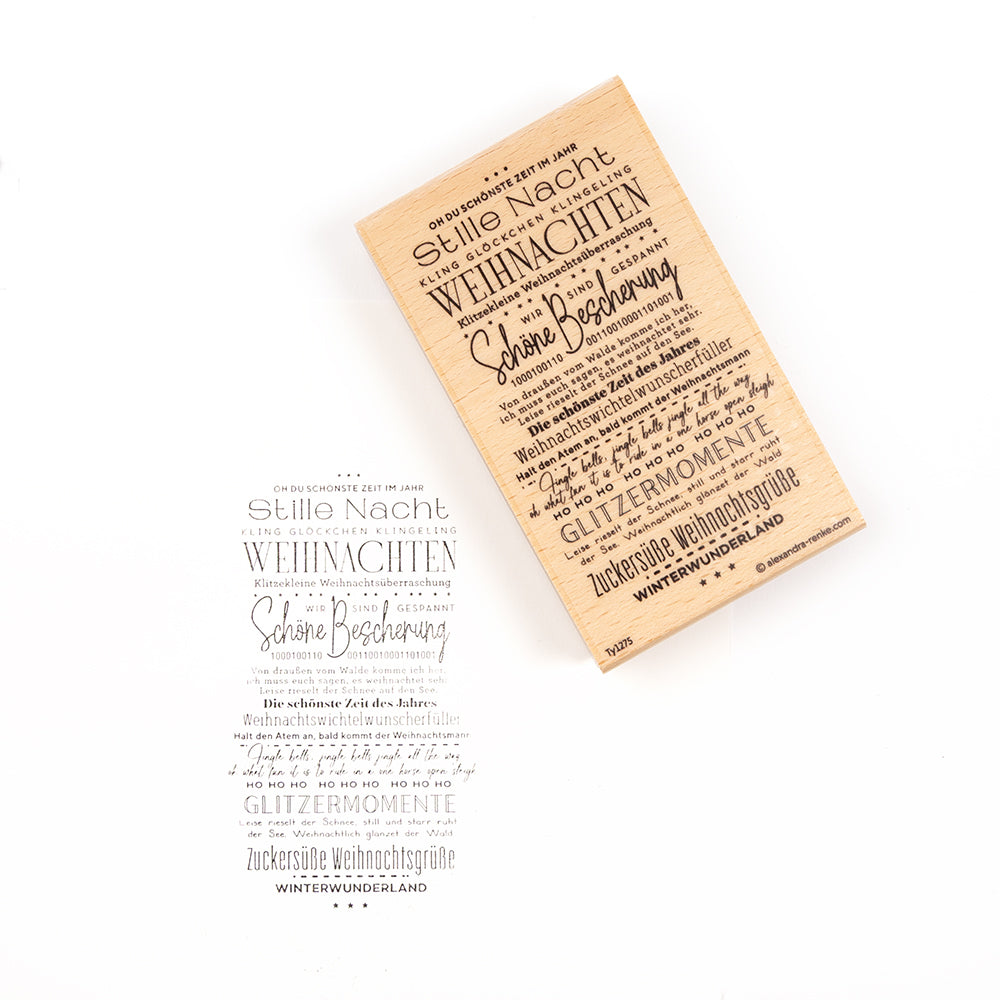 Ein auf Holz montierter Stempel und der dazugehörige Abdruck auf Papier mit einem deutschen Weihnachtsliedtext, der als anschauliches Beispiel für solche Stempelmotive dient.