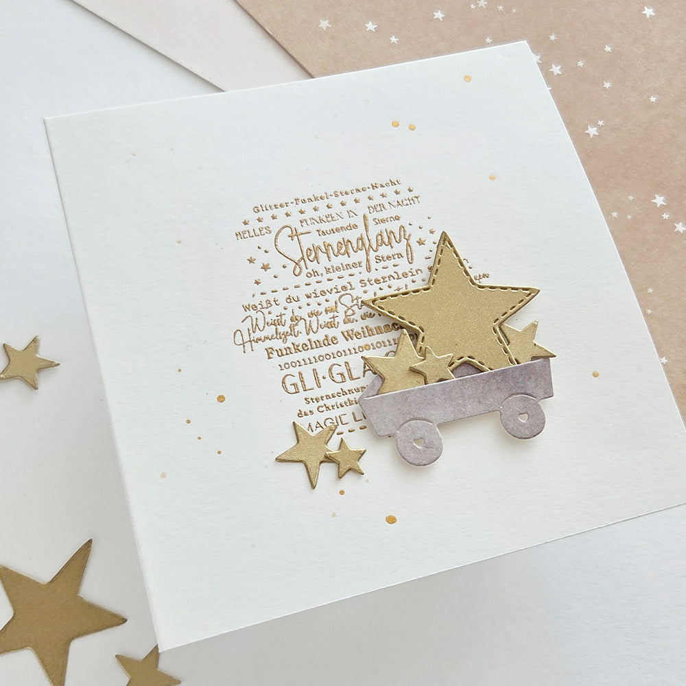 Quadratische Grußkarte mit einer goldgeprägten Stern-Illustration und deutschem Text zu Weihnachtsglitzer.
