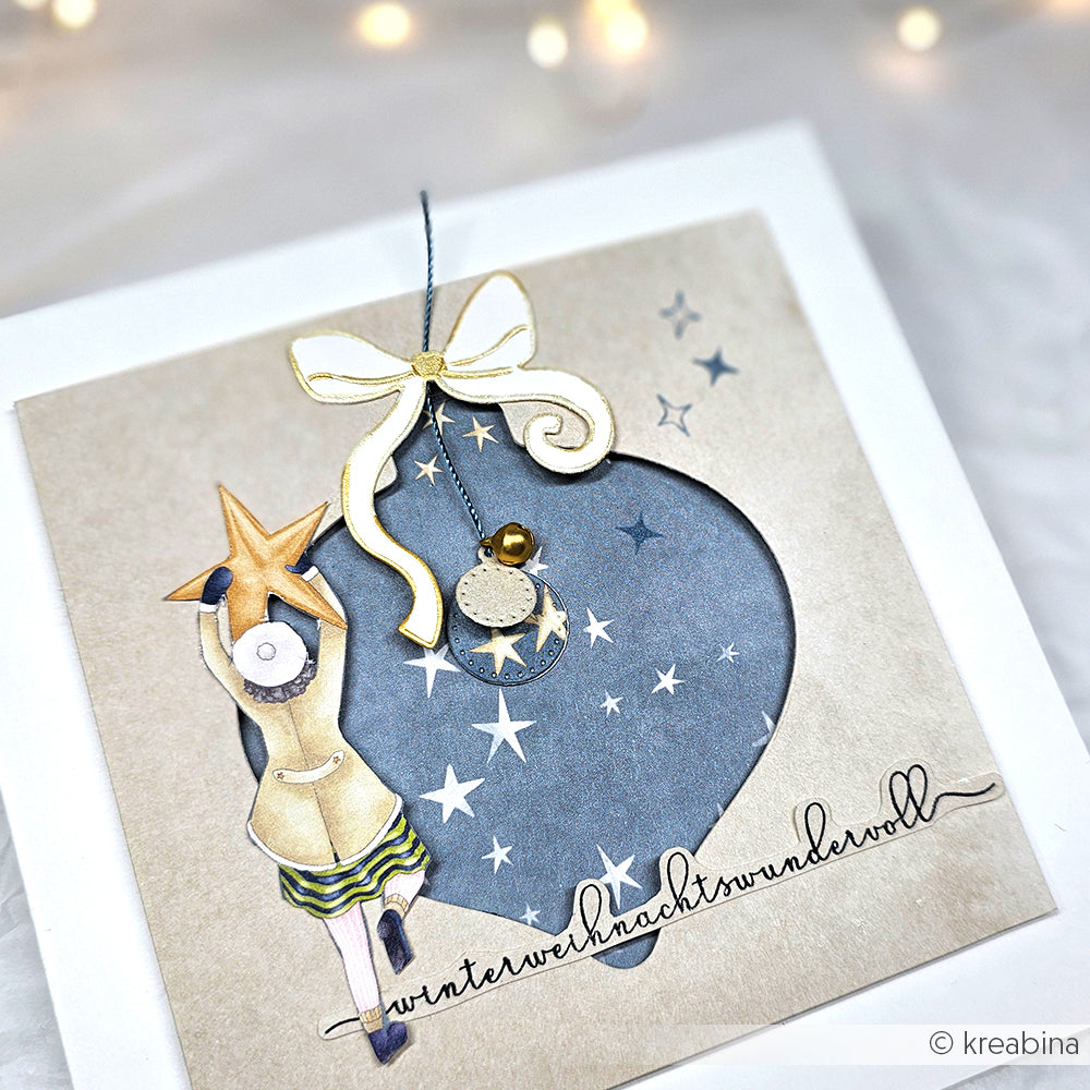 Handgemachte Karte von Alexandra Renke mit einem Mädchen mit Stern, PAPPcut Ornamentkugel, Sternen und goldener Schleife auf beigem Papier - ideal für Buchbinden-Fans und präzise mit Stahlbandstanzen gefertigt.